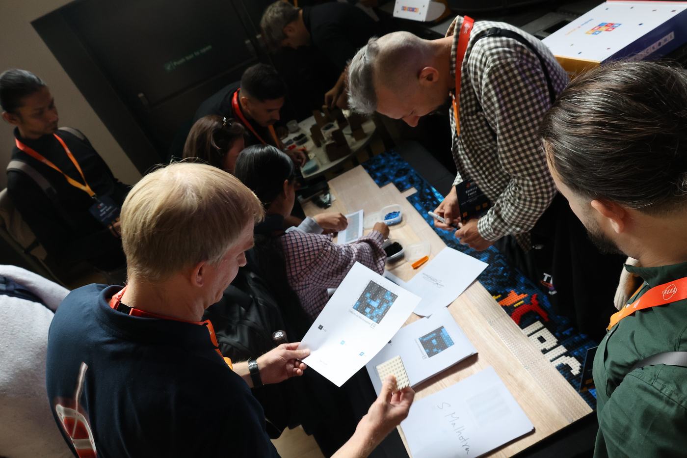Conference delegates building brick plates between sessions at IBIC 2025